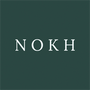 Logo image for Nokh (pronounced noke). The background color is the deep green aroma of evergreen in the woods on a crisp summer morning. The letters, N, O, K, and H are an airy hue of blue; on a sunny day, a wispy winter breeze's piquant kiss